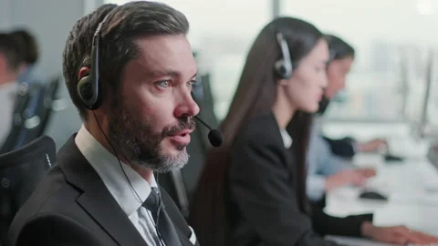 Close Up Portrait Man of a Technical Customer Support Specialist Talking on a Stock Footage 168729180