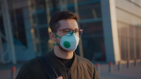 Close up portrait man wearing Protective Face Mask look at camera COVID-19 Stock-Footage 127209907