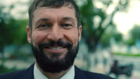 A close-up portrait of a man's chin, an aged man with a beard, standing in the Stock Footage 165437187
