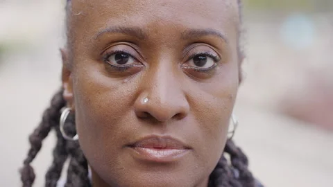 Close up portrait of mature black female looking to camera with no expression Stock Footage