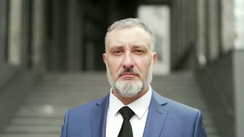 Close-up portrait mature gray haired bearded businessman. Serious Looking at cam Stock Footage 205430606