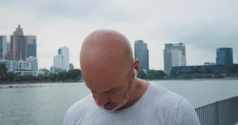 Close up portrait mature man doing warming up neck pre-workout. City park older Stock Footage 312509957