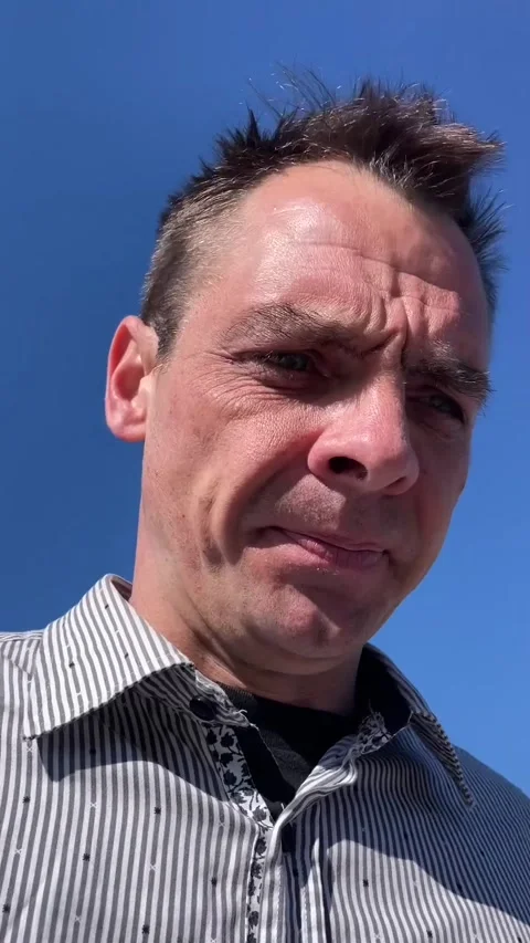Close-up portrait of middle aged man outdoors against clear blue sky Stock Footage 341672917