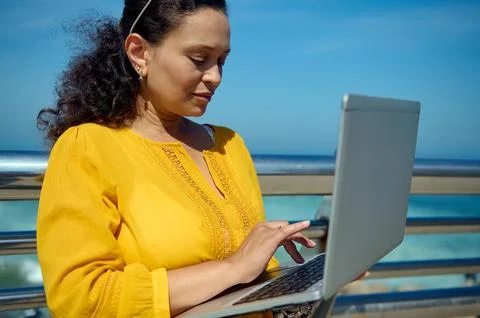 Close-up portrait of a middle aged multi-ethnic business woman using laptop,  Stockfoto's