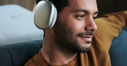 Close-Up Portrait of Middle Eastern Man in Headphones Listening to Music Stock Footage 254516845
