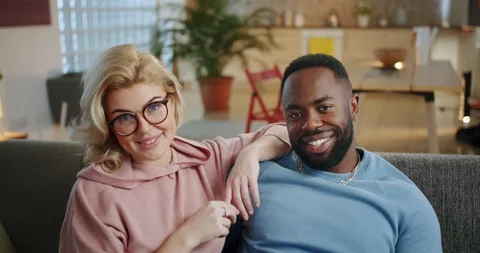 Close up portrait of mixed race couple smiling looking straight to camera inside Stock Footage 123672993