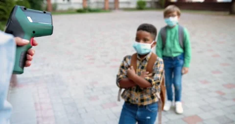 Close up portrait of mixed-races junior students in masks going to school after Video stock 137534739