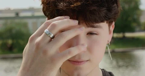 Close-up portrait of modern young guy from generation Z in bright hawaiian shirt Stock Footage 154895517