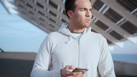 Close up portrait of nice guy looking pensive in city landscape, while holding Stock Footage 105755302