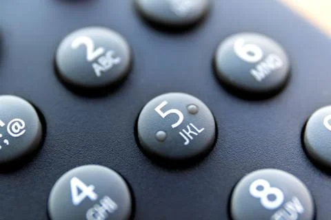 A close up portrait of the numeric buttons of a television remote control. Th Stock Photos