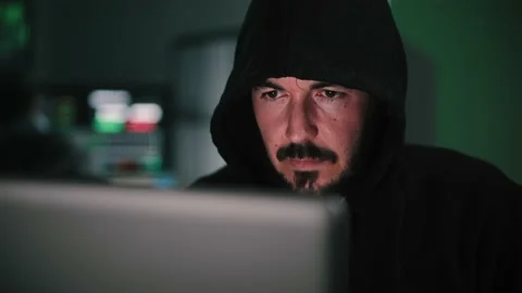 Close up portrait of one hacker looking the screen of a laptop computer, typing Video stock 231680185