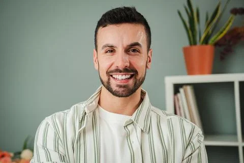 Close up portrait of one handsome guy with perfect white teeth smiling at home Stock Photos