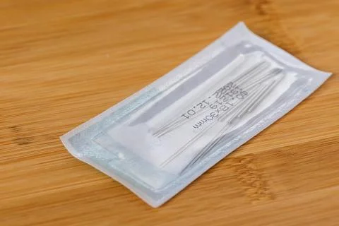 A close up portrait of one package full of tin long acupuncture needles, re.. Foto stock
