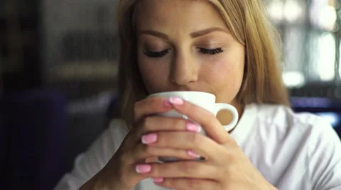 Close-up portrait, pretty young beautiful blond woman with white cup of coffee Stock Footage 67648604