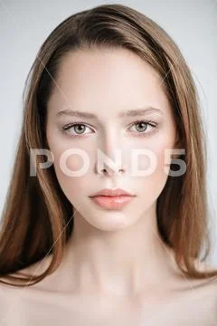 A close up portrait of a pretty young girl posing in the studio over the whit Stock Photos