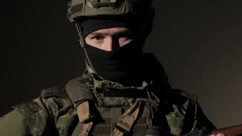 Close-up Portrait of a professional fully equipped soldier reloading a Stock Footage 180191834