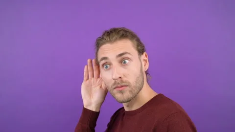 Close-up portrait in profile of a young curious man. The man overhears the news Stock Footage 145472260