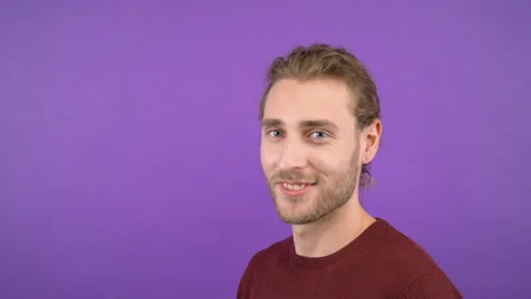 Close-up portrait in profile of a young flirting man. The man winks and sends Stock Footage 145405042