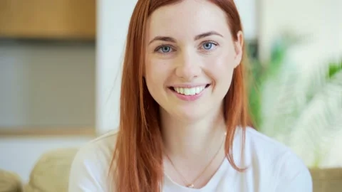 Close-up portrait of a redhaired young happy girl or woman happily smiling  Stock Footage 155315884