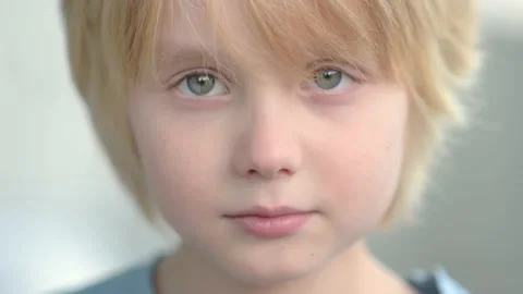 Close-up portrait of sad and thoughtful school-age child Stock Footage 233605865