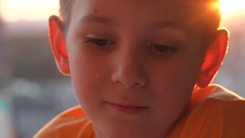 Close up portrait of sad pensive boy during sunset Video stock 327035435