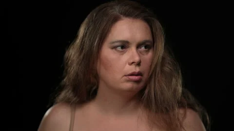 Close-up portrait scared plus size woman looking around with worried facial Stock Footage 167603381