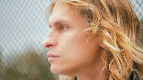 Close Up portrait of sensual man with blue eyes and long blond hair, turn his he Stock Footage 119869367