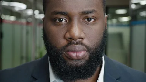 Close-up portrait of serious African American bearded businessman in the Stock Footage