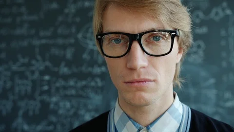 Close-up portrait of serious intelligent man wearing glasses looking at camera Stock Footage 124881577