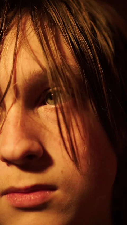 Close up portrait of serious teenager with dramatic expression and hair covering Stock Footage 335828126