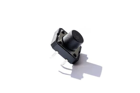 A close up portrait of a small push button. The electric component is used in Stock Photos