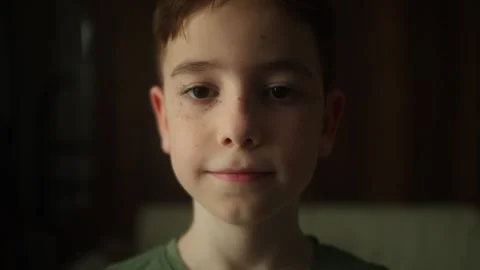 Close up portrait of a smiling 10 year old boy looking directly at the camera 스톡 동영상 340227875