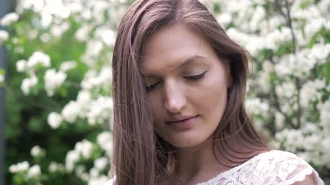 Close-up portrait of smiling brown long hared girl in beautiful white dress Stock Footage 155089466
