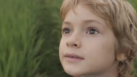 Close up portrait of smiling child looking at sky in summer day Video stock 94877171
