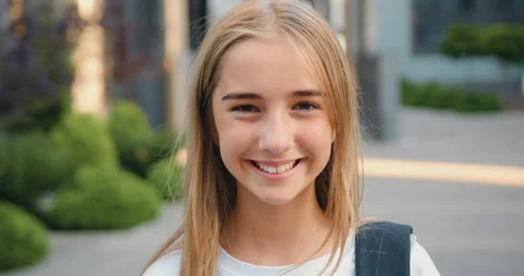 Close up portrait of smiling female elementary school student wearing backpack Stock Footage 248614910