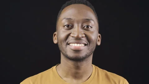 Close-up portrait of smiling friendly african young man. Stock Footage 228847101
