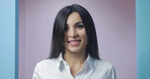 CLOSE-UP PORTRAIT OF A SMILING JOYFUL YOUNG WOMAN LOOKING AT THE CAMERA CONCEPT Stock Footage 143751906