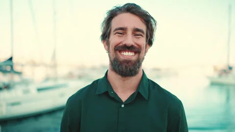 Close-up portrait of a smiling man with a beard on the embankment, on a yacht Stockbeeldmateriaal 226879689