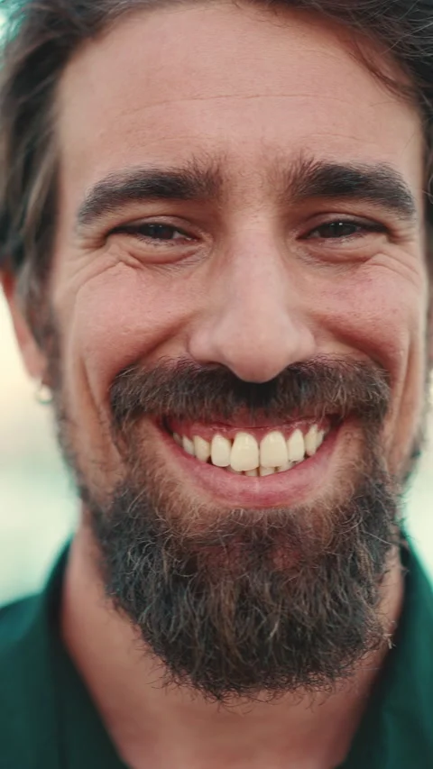 Close-up portrait of a smiling man with a beard on the embankment Stock Footage 227005738