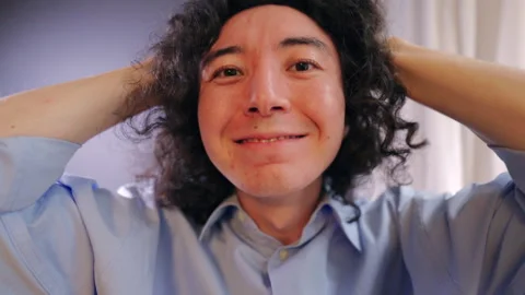 Close up portrait of smiling man relaxing with hands behind head indoors Vídeo Stock 324622414