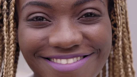 Close-up of a portrait of a smiling young African woman looking at the camera. Stock Footage 163632034