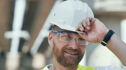 Close up portrait of smiling young master builder in protective white hard hat Stockbeeldmateriaal 200945826