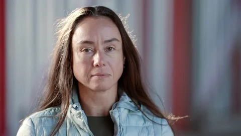 Close-up portrait of a thoughtful middle-aged woman on the street in sunny Stock-Footage 162023248