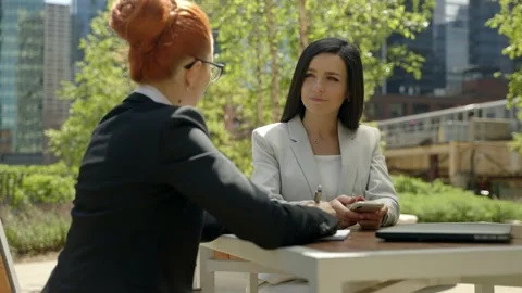 Close-up portrait of two beautiful concentrated business women talking at the Stock Footage 155946571
