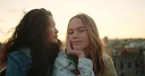 Close up portrait of two cheerful young female friends resting together at Stock Footage 125307743