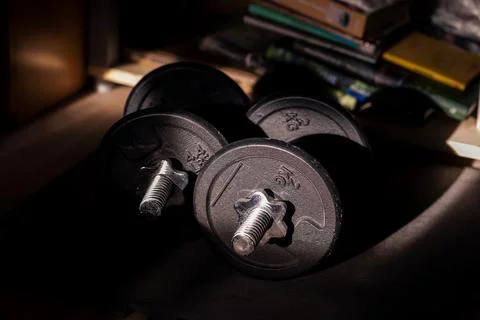 A close portrait of two dumbbell weights lying on a small mat ready to be u.. Stock Photos