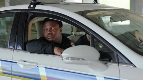 Close up portrait two men cops sitting in patrol car accepting emergence call Stock Footage 112954743