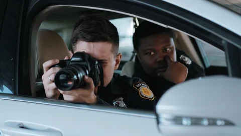 Close up portrait two men cops sitting in patrol car accepting emergence call Video stock 113000763