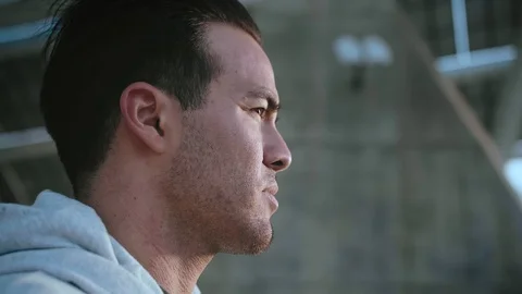 Close up portrait of urban pensive Hispanic man, standing alone and looking into Stock Footage 105754342