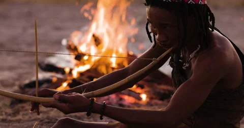Close-up portrait view of San people (Bushmen)playing a traditional musical Stock Footage 155431007